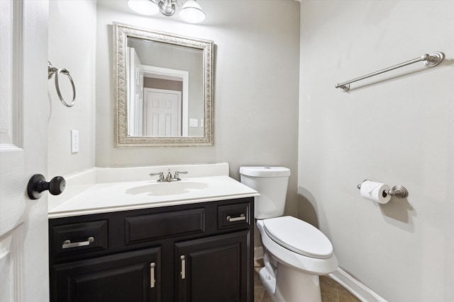 bathroom with vanity, toilet, and tile patterned flooring