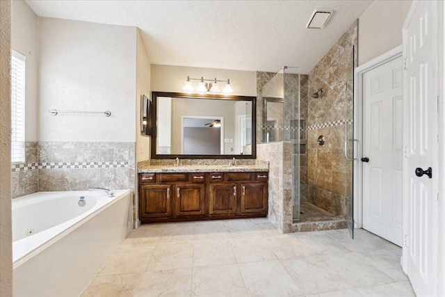 bathroom featuring tile patterned floors, a textured ceiling, vanity, ceiling fan, and plus walk in shower