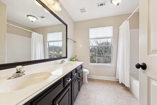 full bathroom with vanity, toilet, tile patterned flooring, and a wealth of natural light