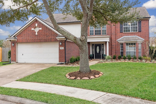 view of property featuring a front yard and a garage