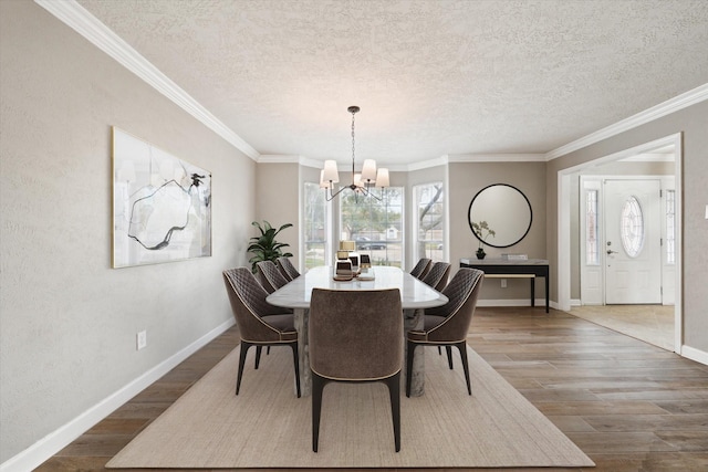 dining room with crown molding, a notable chandelier, and hardwood / wood-style flooring