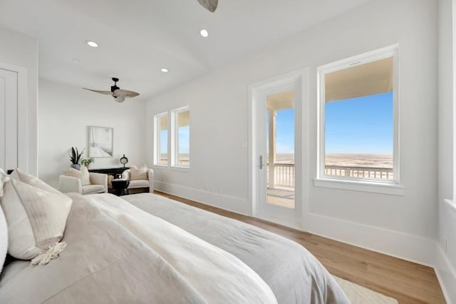 bedroom featuring ceiling fan, light wood-type flooring, access to outside, and multiple windows