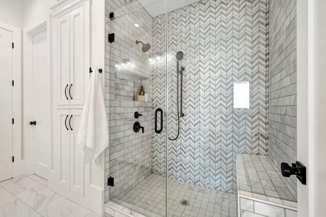 bathroom featuring a shower with door