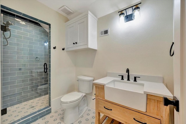 bathroom with vanity, toilet, and a shower with shower door