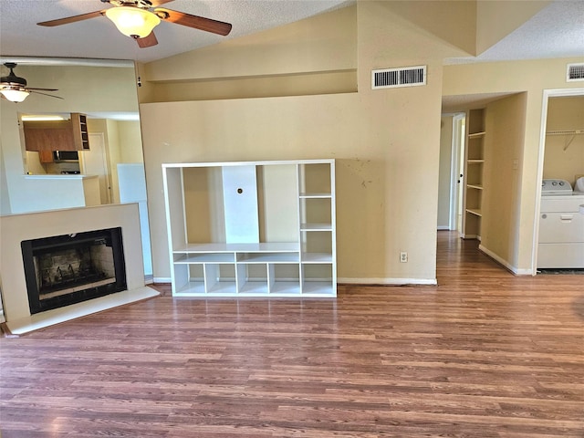 unfurnished living room featuring ceiling fan, wood-type flooring, a textured ceiling, and high vaulted ceiling