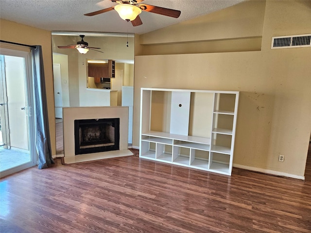 unfurnished living room with a textured ceiling, ceiling fan, vaulted ceiling, and hardwood / wood-style flooring