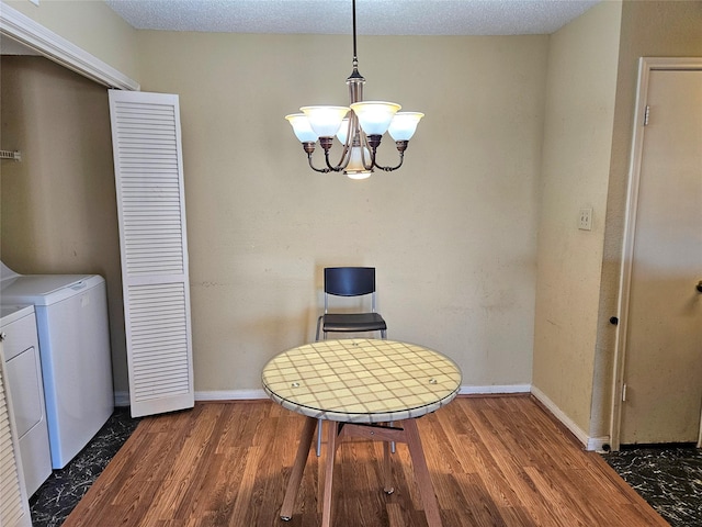 dining area featuring a notable chandelier, separate washer and dryer, and dark wood-type flooring