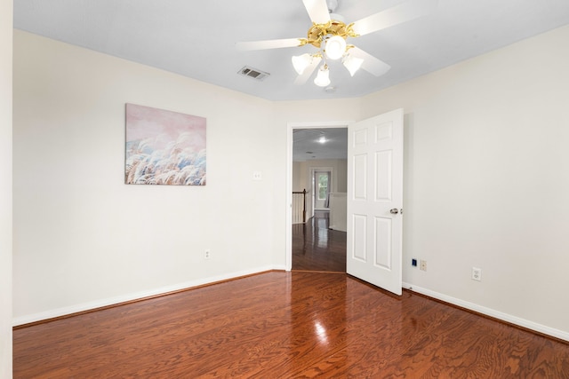 empty room with dark wood-type flooring and ceiling fan