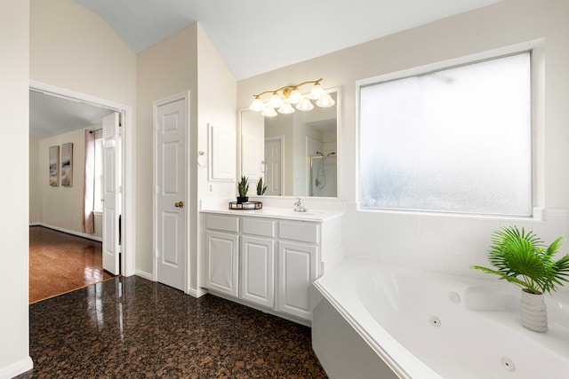 bathroom with separate shower and tub, vaulted ceiling, and vanity