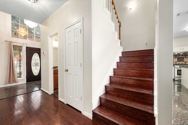 foyer entrance featuring dark wood-type flooring