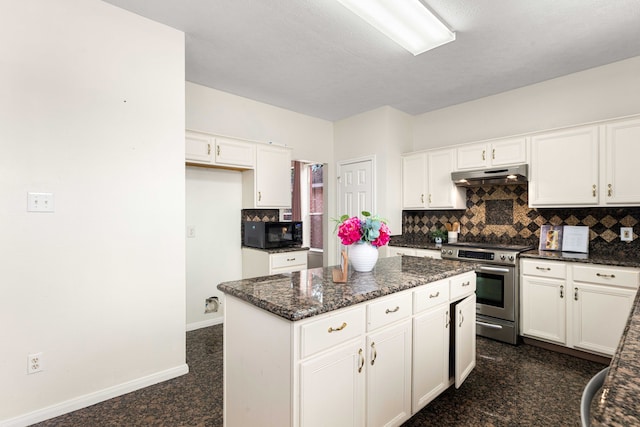 kitchen with white cabinets, dark stone countertops, stainless steel range with electric stovetop, and decorative backsplash