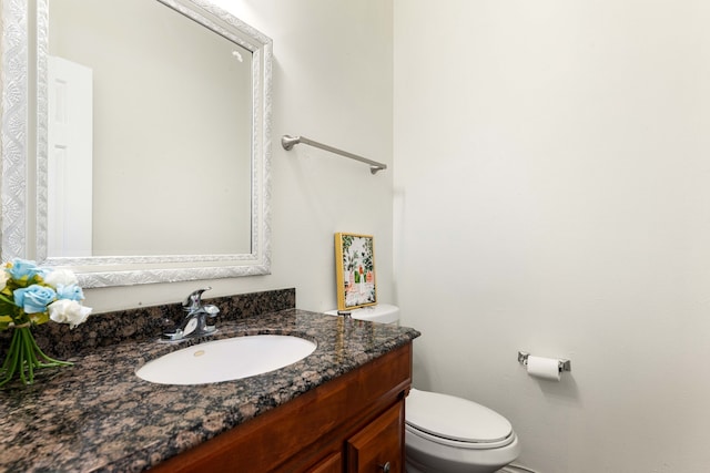 bathroom with toilet and vanity