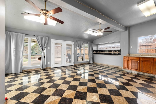 unfurnished living room with a textured ceiling, french doors, and vaulted ceiling with beams