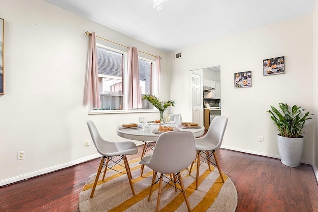 dining area with dark wood-type flooring