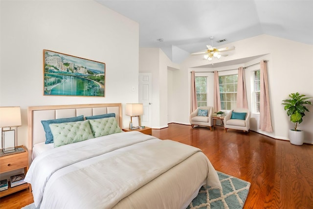 bedroom with ceiling fan, vaulted ceiling, and dark hardwood / wood-style floors