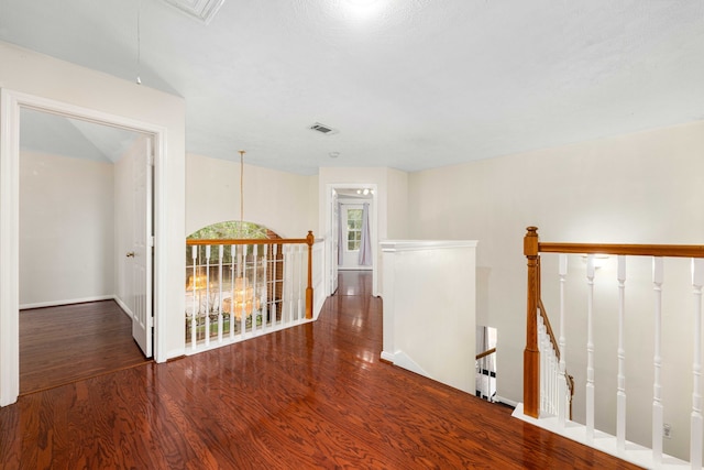 hallway with dark hardwood / wood-style floors