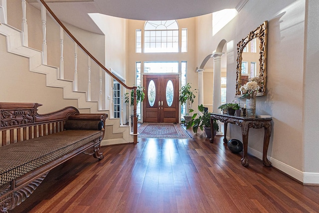 foyer with a high ceiling and dark hardwood / wood-style flooring