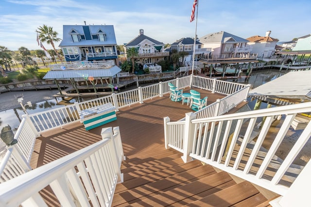 dock area with a residential view and a deck with water view