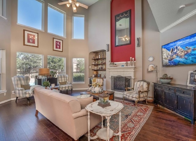 living room with ornamental molding, a textured ceiling, ceiling fan, high vaulted ceiling, and dark hardwood / wood-style floors