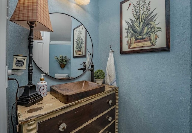 bathroom featuring vanity and ornamental molding