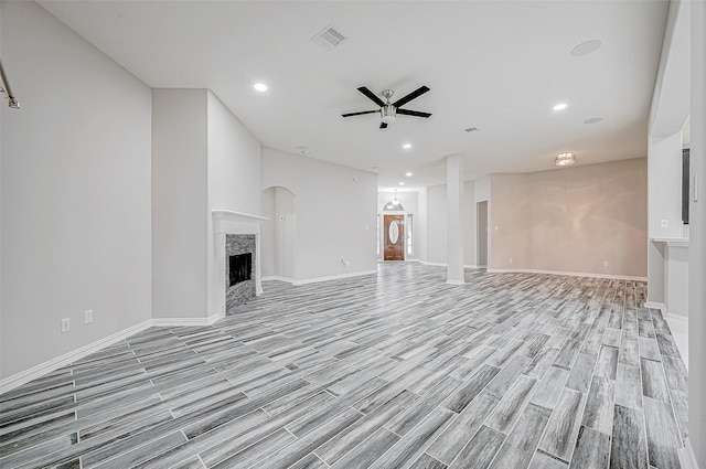 unfurnished living room with ceiling fan and light wood-type flooring