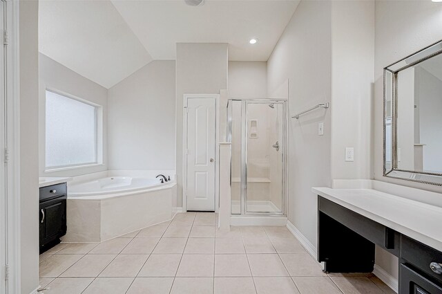 bathroom featuring lofted ceiling, tile patterned floors, separate shower and tub, and vanity