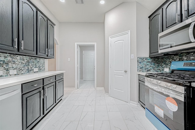 kitchen with appliances with stainless steel finishes and backsplash