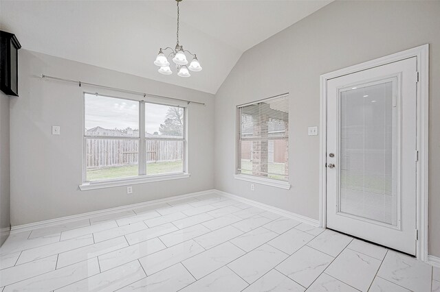 unfurnished dining area featuring a chandelier and vaulted ceiling