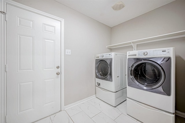 clothes washing area with washer and clothes dryer