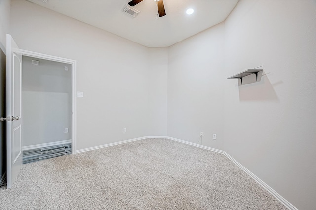 carpeted spare room with ceiling fan