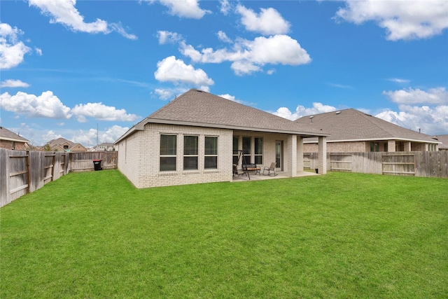 back of property featuring a patio area and a yard