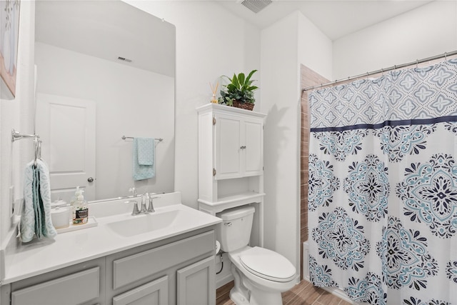 bathroom featuring hardwood / wood-style floors, vanity, and toilet