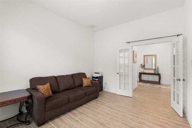 living room featuring light wood-type flooring and french doors