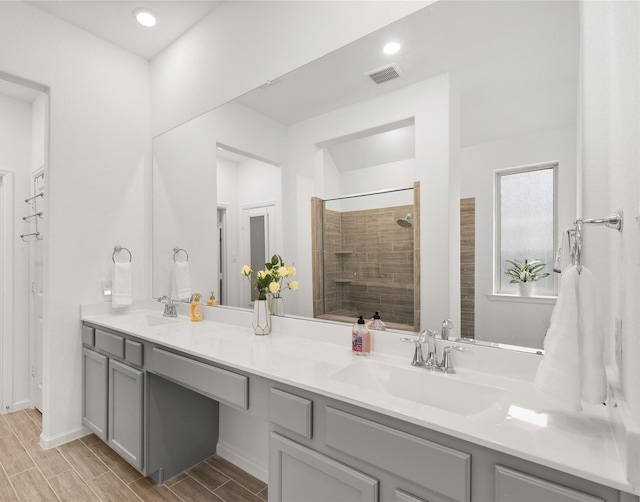 bathroom featuring vanity and a tile shower