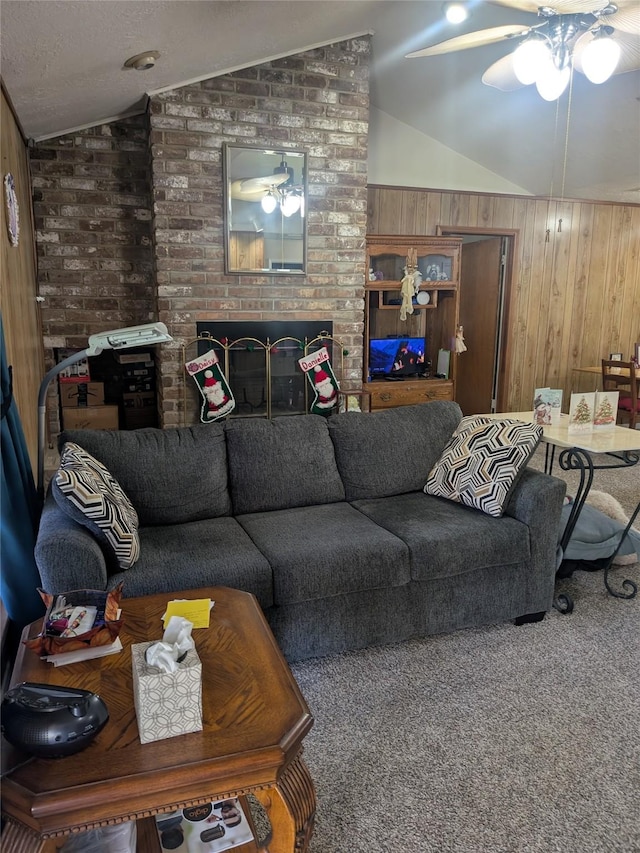 living room with ceiling fan, carpet floors, a textured ceiling, vaulted ceiling, and wooden walls