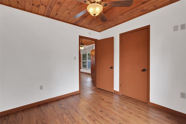 spare room with light hardwood / wood-style floors, crown molding, and wooden ceiling