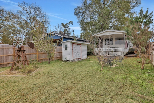 view of yard featuring a porch and a storage shed