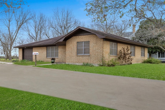 view of front of house with a front yard and a garage