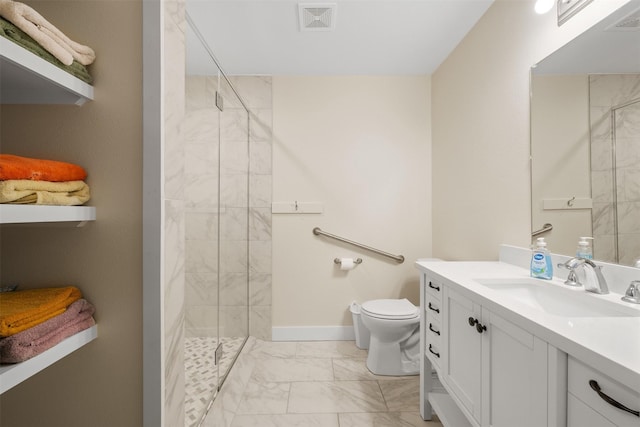 bathroom with a tile shower, vanity, and toilet