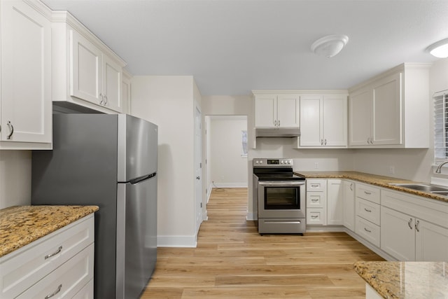 kitchen featuring light stone countertops, stainless steel appliances, light hardwood / wood-style floors, white cabinets, and sink