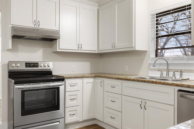 kitchen featuring light stone counters, hardwood / wood-style floors, white cabinetry, appliances with stainless steel finishes, and sink