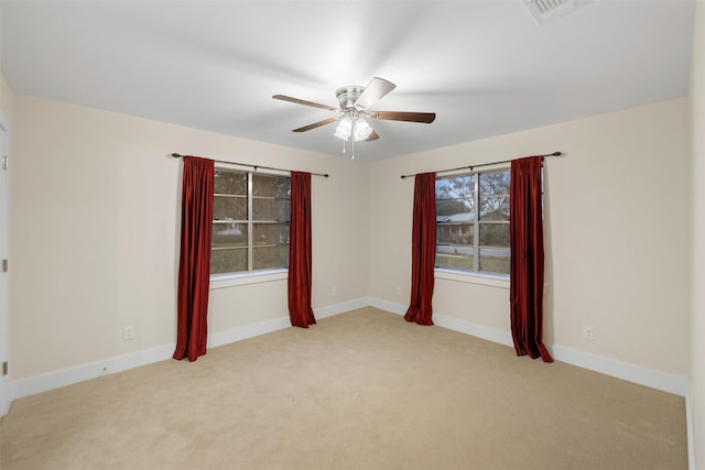 unfurnished room with ceiling fan and light colored carpet