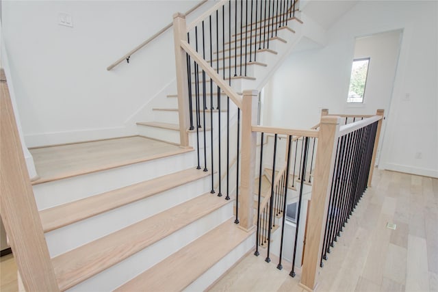 staircase with hardwood / wood-style floors