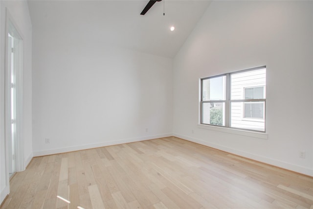 unfurnished room featuring high vaulted ceiling, light hardwood / wood-style floors, and ceiling fan