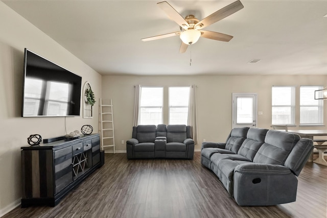 living room with ceiling fan and dark wood-type flooring