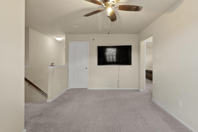 empty room featuring light carpet and ceiling fan