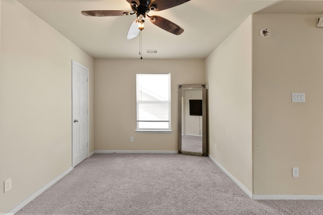 empty room with ceiling fan and light colored carpet