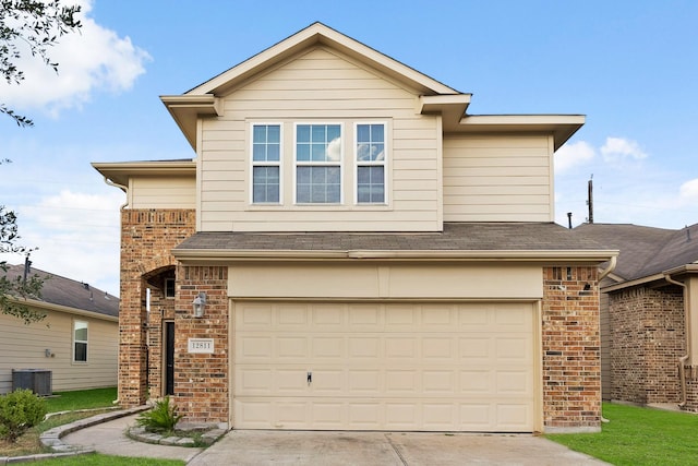 view of front of home with cooling unit and a garage