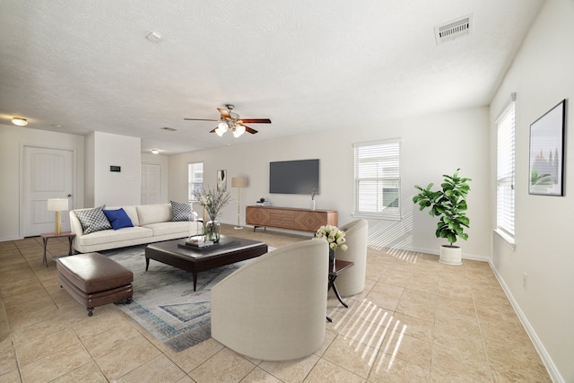 tiled living room with ceiling fan