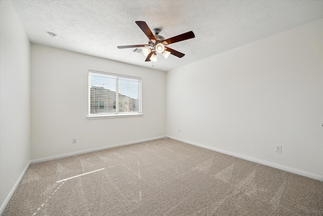 carpeted empty room featuring a textured ceiling and ceiling fan